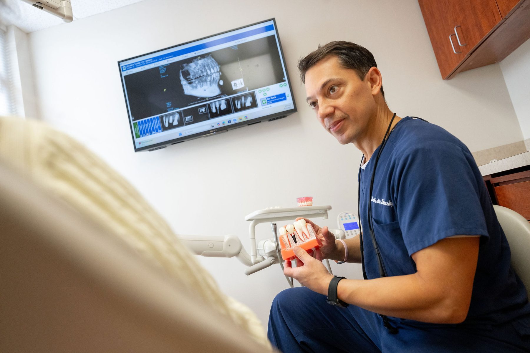 Dr. Zalewsky reviewing dental model